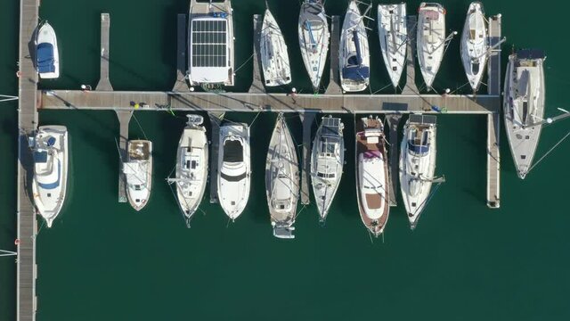 Aerial top down view of a yacht marina with many yachts