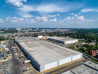 Huge warehouse building with flat roof and cars near city - 463898464