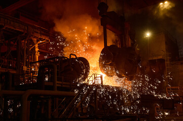 Pouring molten metal into a metallurgical electric arc furnace