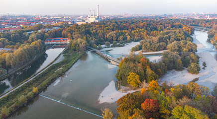 Aerial view of Isar river flowing into Munich and Thalkirchen bridge with cars in a beautiful...