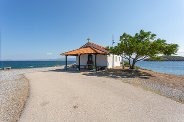 The Orthodox Church of St. Nicholas in Greece, on Kassandra peninsula in Halkidiki, Paliouri - Cape Kanistro. Summer day with clear blue sky in background.