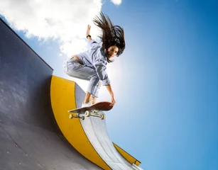 Gordijnen Skateboarder doing a jumping trick © Andrey Burmakin