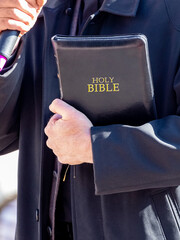 Pastor with a Bible in his hand during a sermon. The preacher delivers a speech