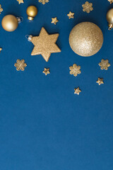 Christmas holiday banner background with copyspace. Flat lay frame with christmas balls and decorations on a blue background