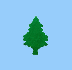 Fototapeta na wymiar green tree made of green velvet cardboard on a blue background