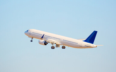 The plane is preparing to fly at the airport. Airplane on the runway at the airport. The turbine of the aircraft is warming up, the landing gear is preparing for flight. The plane flies in the sky.