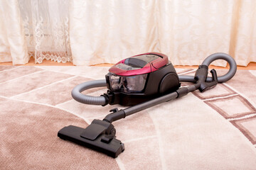 Vacuum cleaner in the room on the carpet, cleanliness in the house, cleaning