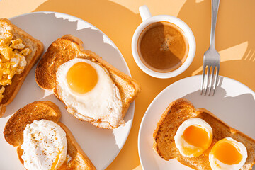 fried Toast bread with four different types of cooked chicken eggs, scrambled eggs, fried eggs, poached egg and creamed egg. Breakfast of chicken eggs. methods of making eggs for breakfast