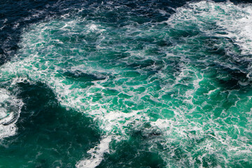Fototapeta na wymiar Violent churning blue and green ocean