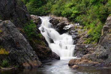Summer swimming hole with a waterfall