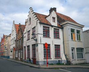 Fototapeta premium Street with scenic traditional houses in medieval style in the old town of Bruges, Belgium