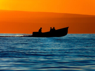 Fishing boat on the water at dusk - obrazy, fototapety, plakaty