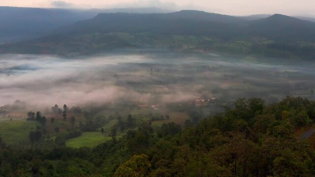 4K drone footage of misty landscape view on the famous sunrise viewpoint in Phu Sa nao hill in Muang Chet Ton, Uttaradit province, Thailand.