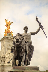 Fototapeta premium Queen Victoria Monument, London, 2021. The Progress statue is a youth, laurel-crowned, and bearing a torch in his left hand . Focus is on the sculpture infront of the memorial