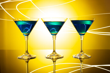 blue coctail splash. blue coctail drink with ice cubs. Blue lagoon non-alcoholiccoctail coctail on clean blue background