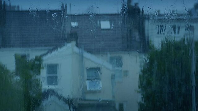 Window View Of Houses On Rainy Evening