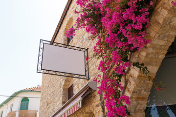 Beautiful narrow streets in an old mountain village. Pano Lefkara village, Cyprus. Street with flower pots and masonry. Stone exterior of old buildings with flowers on the streets