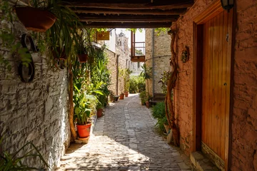 Gordijnen Beautiful narrow streets in an old mountain village. Pano Lefkara village, Cyprus. Street with flower pots and masonry. Stone exterior of old buildings with flowers on the streets © svetlichniy_igor