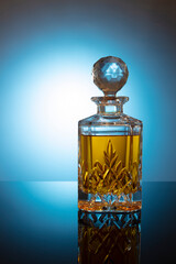 bottle of cognac brandy on table on blue background