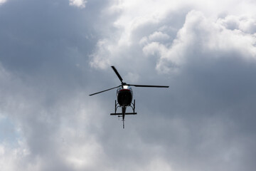 helicopter in the sky against the background of clouds
