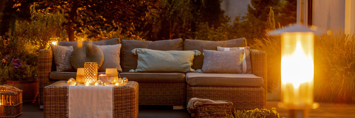 Warm summer night in the garden with trendy furniture, lights, l