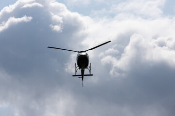 Fototapeta na wymiar helicopter in the sky against the background of clouds