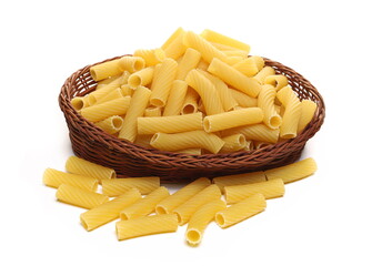 Uncooked short tubes shape pasta also known as tortiglioni or elicoidali in wooden wicker basket isolated on white background