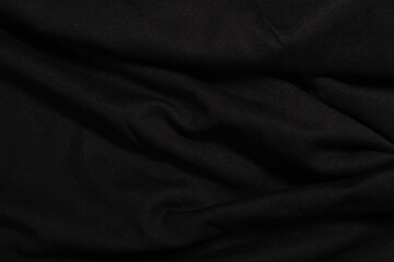Fototapeta premium Dark wavy background made of black fabric texture. Low key