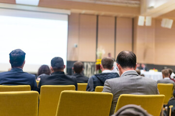 Speaker giving a talk in conference hall at business meeting event.