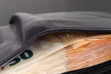 Stack of 50 euro banknotes in a wallet. Wallet with money up close. Soft focus