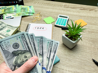 Adult man counting money at the table