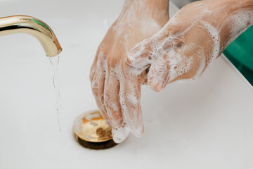 Washing of hands under running water