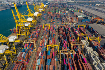 Container ship in export and import business and logistics. Shipping cargo to harbor by crane. Water transport International. Aerial view and top view.