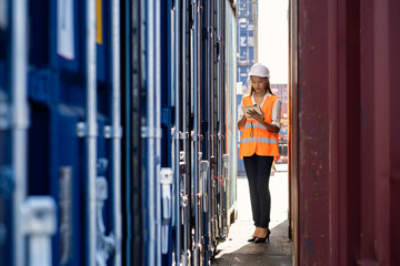 Engineers are overseeing the transportation of cargo with containers inside the warehouse. Container in export and import business and logistics.