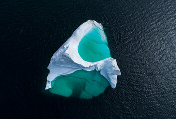 Giant iceberg with a blue pool from above