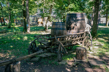 Old wooden cart with wine barrels