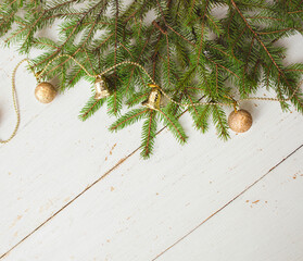 Christmas background. Green spruce branches on a wooden white background. Copy space