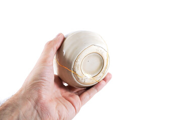 Antique Japanese Kintsugi, beige Kintsugi vase restored with gold cracks. Wabisabi pottery