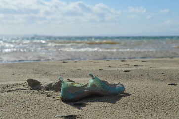 Fototapeta na wymiar Beach pollution, environmental pollution, empty used dirty plastic bottles, spilled garbage on the beach