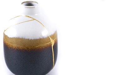 Antique Japanese Kintsugi vase restored with gold cracks. Wabisabi pottery