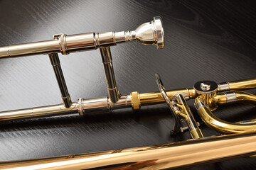 Detail of mouthpiece and central zone of trombone on black