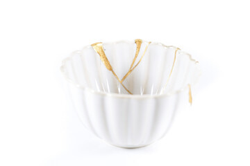 isolated Japanese kintsugi bowl restored with real gold cracks