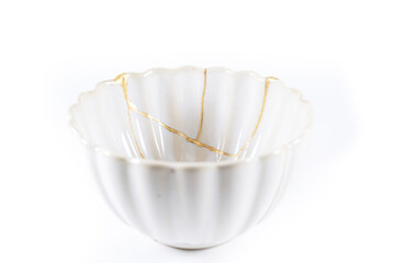 isolated Japanese kintsugi bowl restored with real gold cracks