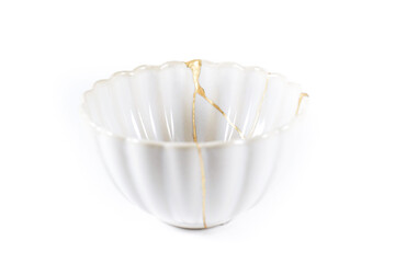 isolated Japanese kintsugi bowl restored with real gold cracks