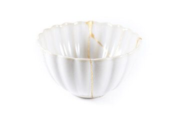 isolated Japanese kintsugi bowl restored with real gold cracks