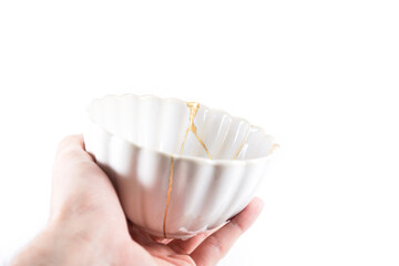 isolated Japanese kintsugi bowl restored with real gold cracks