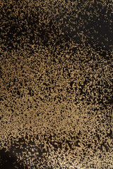 spray paint drops on gold paper background