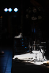 Glasses, plate and cutlery on the table. Table setting in the restaurant.