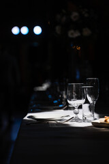 Glasses, plate and cutlery on the table. Table setting in the restaurant.