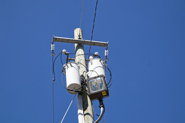 Power transformers on a pole and light